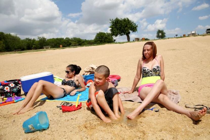 
Lewisville Lake’s Stewart Creek Park had plenty of sun and sand for Eliana Terrell (left)...