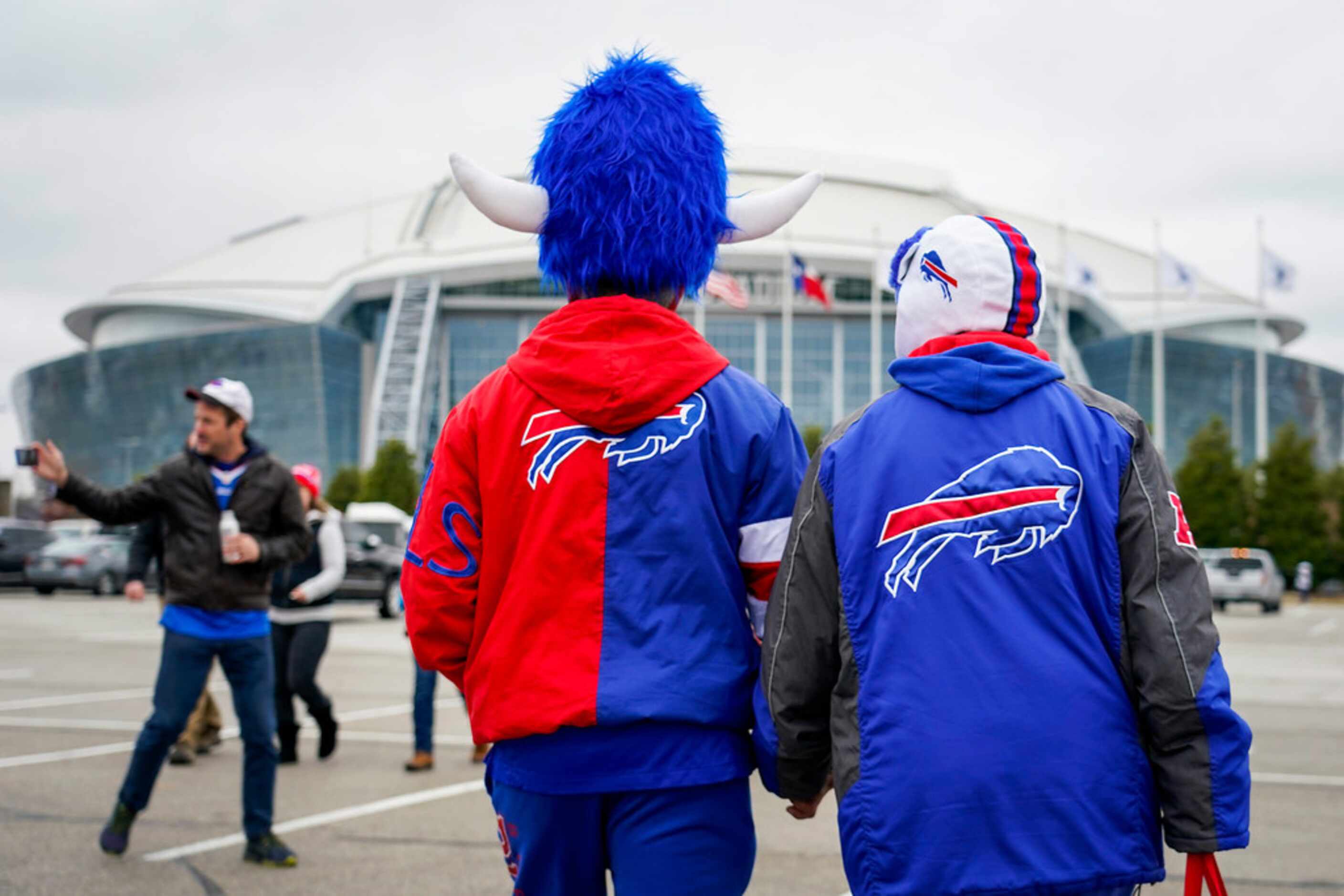 Buffalo Bills fan Sam Huerta and Diana Medina head to the stadium before an NFL football...