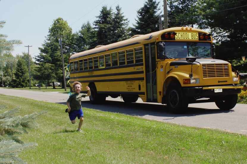 Daniel Barden races the school bus in this photo taken by his father, Mark Barden, who...