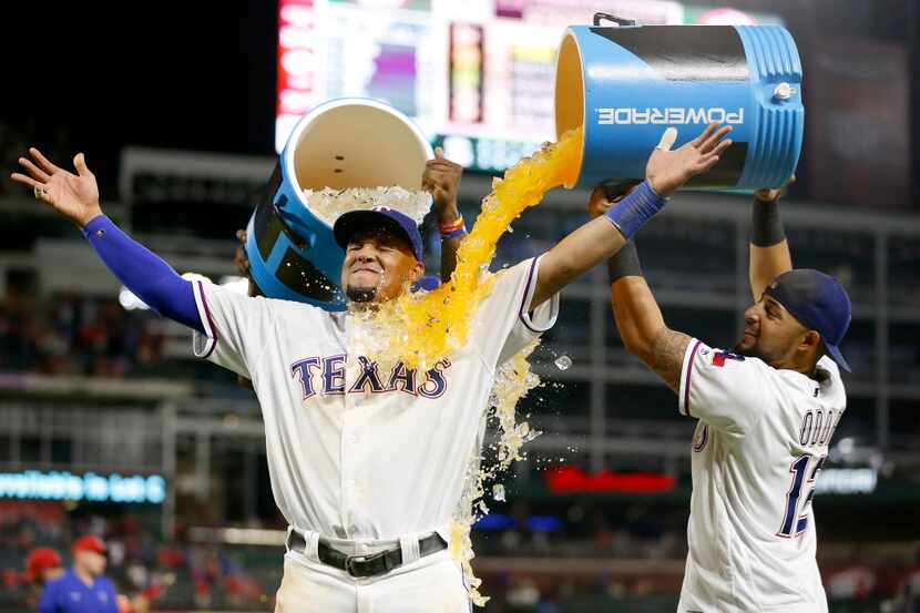 Texas Rangers left fielder Carlos Gomez (14) gets doused by second baseman Rougned Odor (12)...