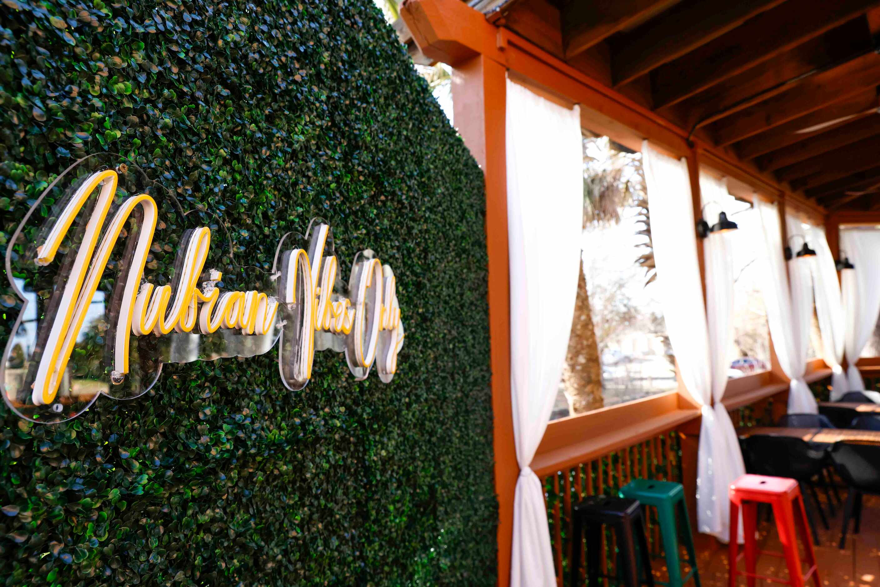 In one corner of the patio at Cafe Nubia in Dallas, a photo wall invites guests to take...