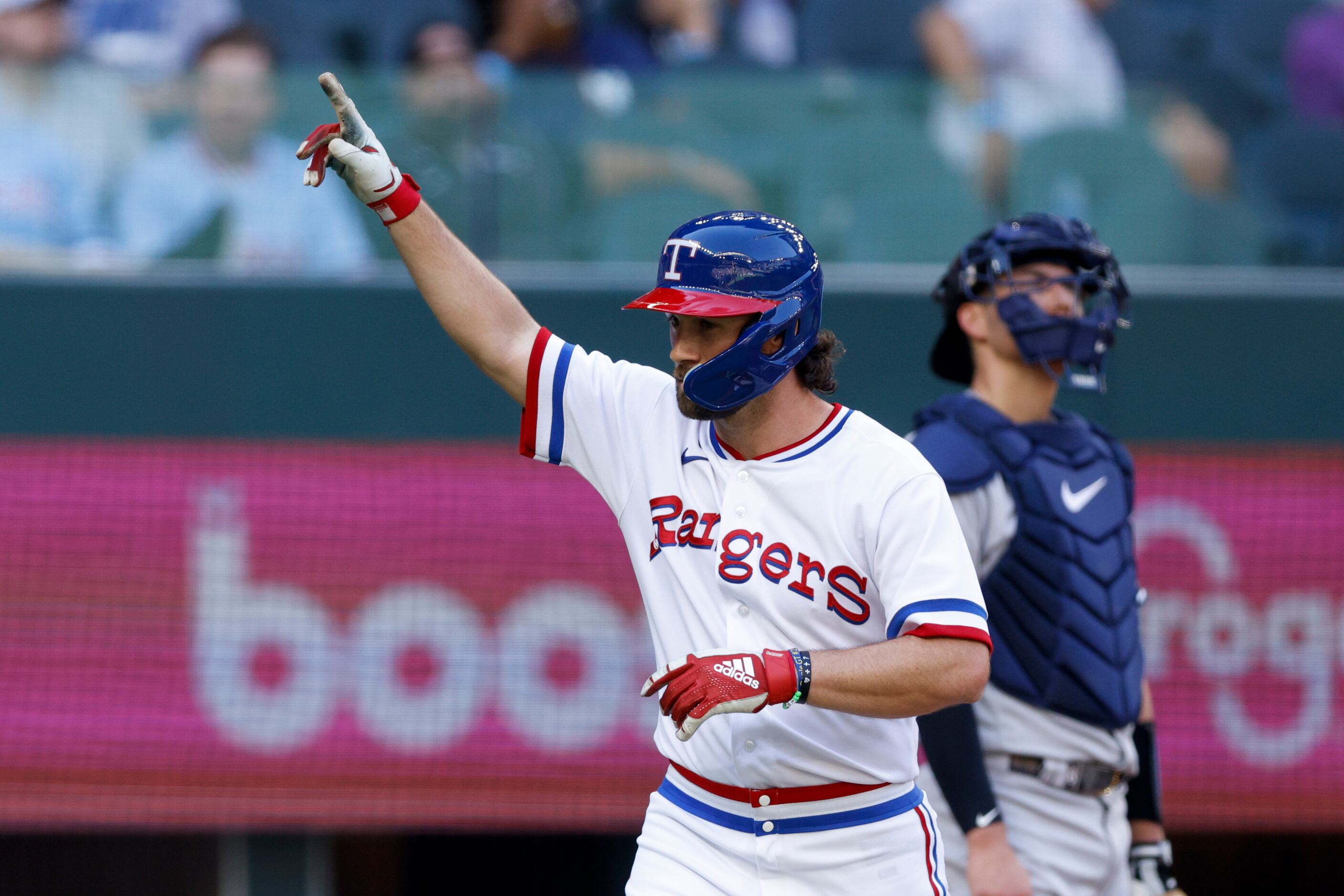 Texas Rangers left fielder Charlie Culberson (11) celebrates a home run after crossing home...