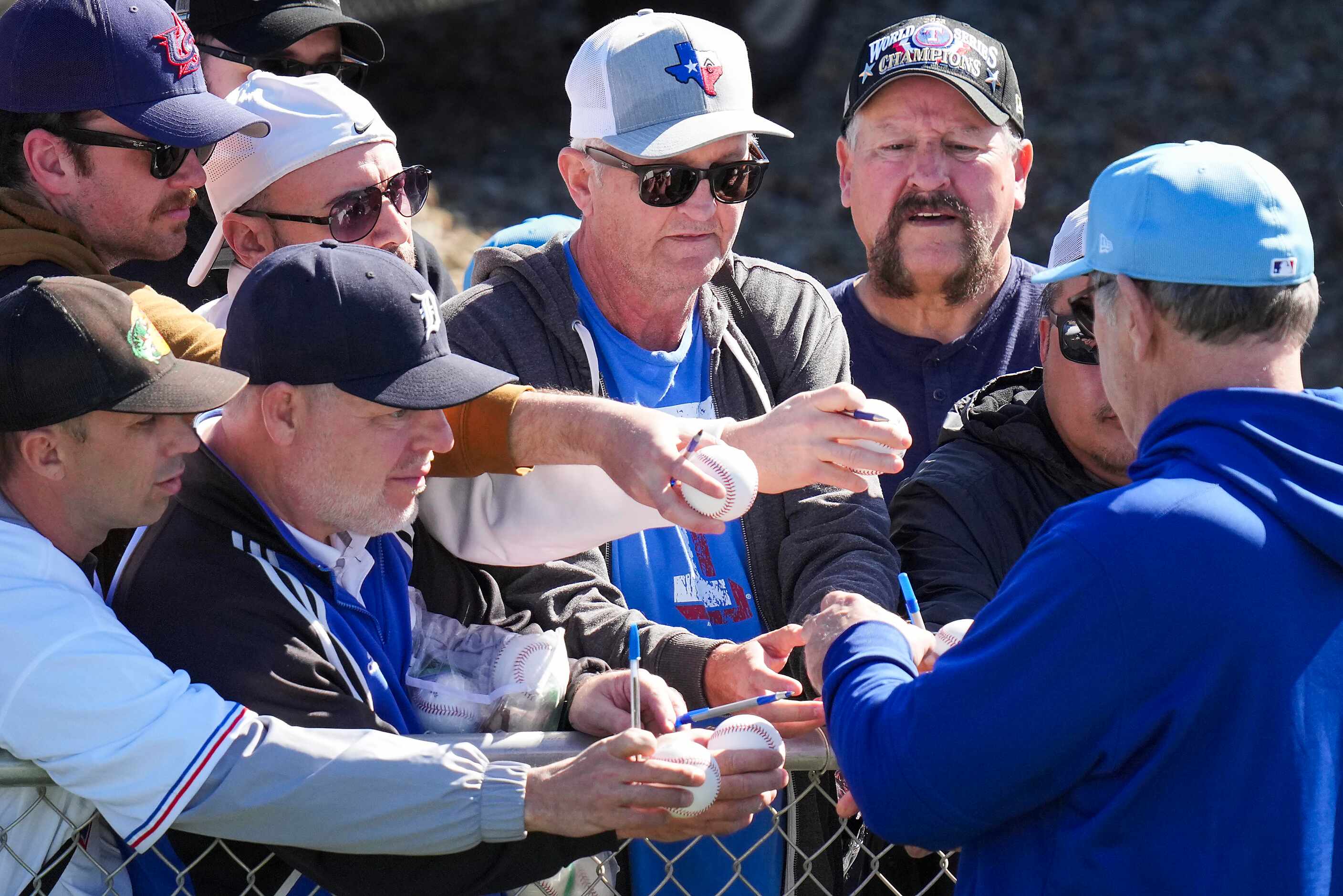 Texas Rangers manager Bruce Bochy stops to sign autographs during the first Spring Training...