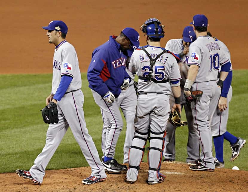 FILE - Texas Rangers relief pitcher Mike Adams is pulled from the game in the seventh inning...