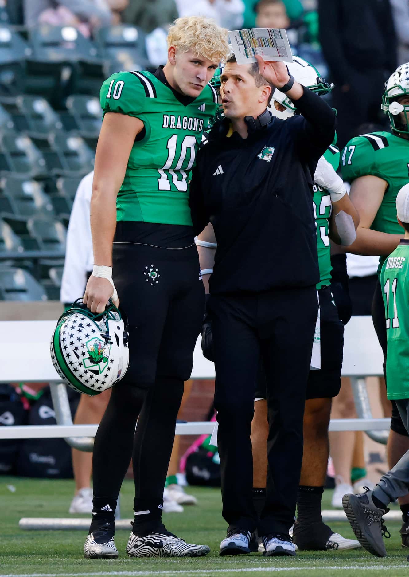 Southlake Carroll head coach Riley Dodge confers with his quarterback Graham Knowles (10)...