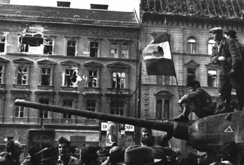 Freedom fighters sat atop a tank with a revolutionary flag in Budapest during the uprising...