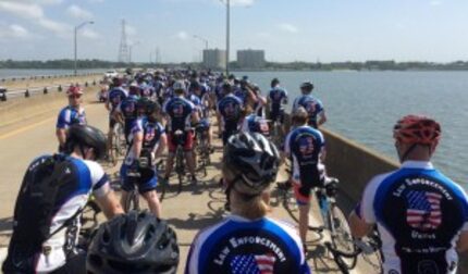  Officers on a bridge in the Road to Hope cycling event.