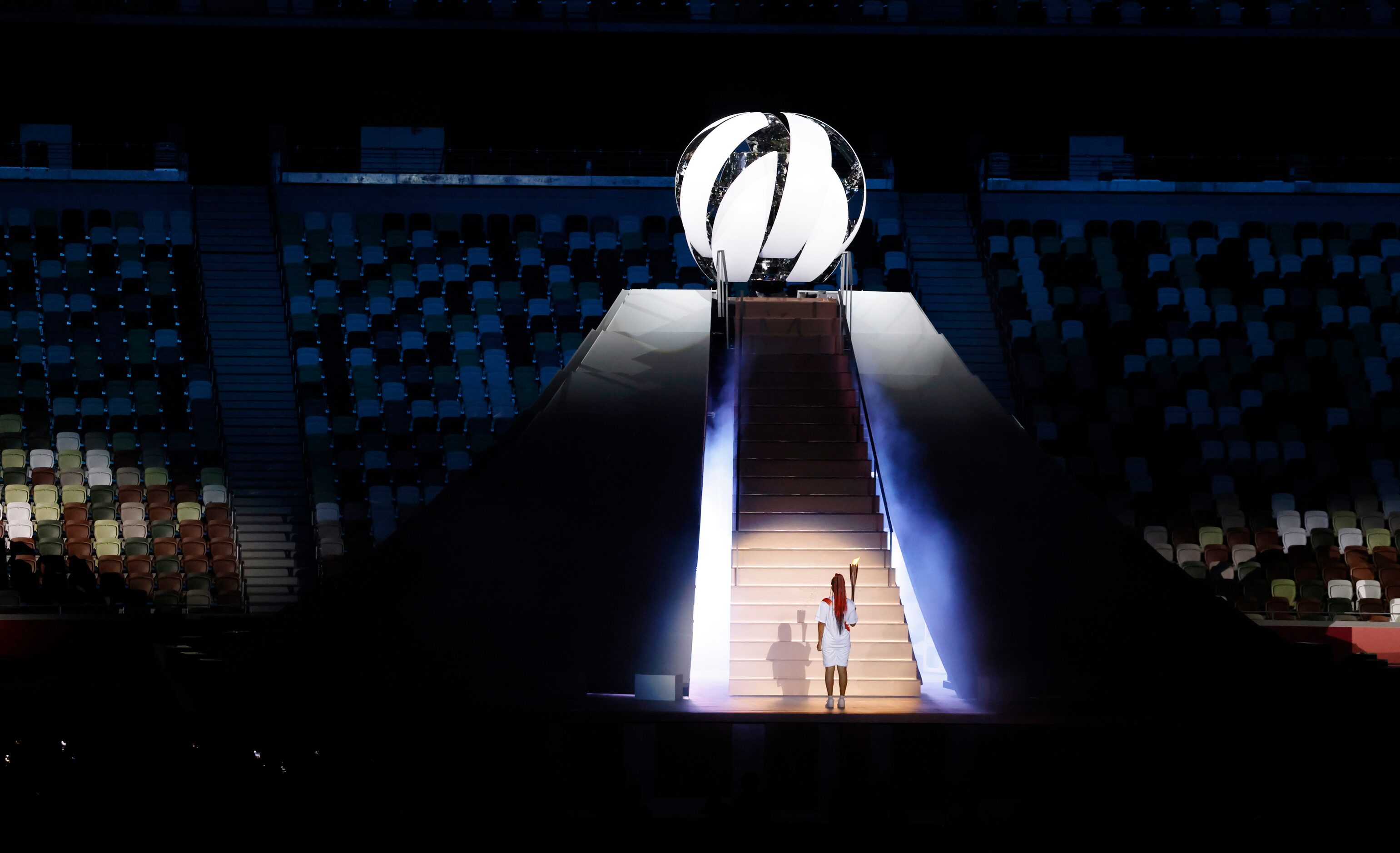 Naomi Osaka prepares to light the Olympic cauldron during the opening ceremony for the...