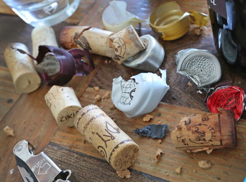 The table becomes cluttered with corks and wrappings from old wine bottles.