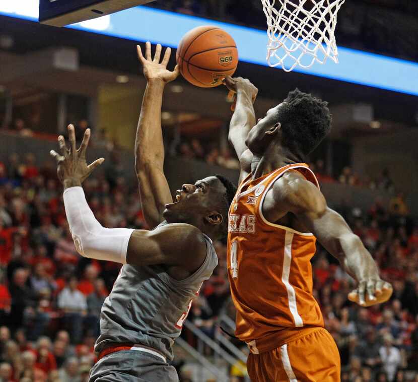 Texas' Mo Bamba (4) blocks the shot by Texas Tech's Norense Odiase (32) during the first...