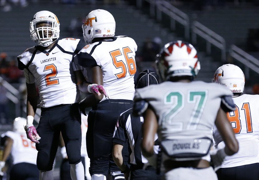 Lancaster wide receiver Cantrell Thomas (2) celebrates with offensive lineman Tre Walker...