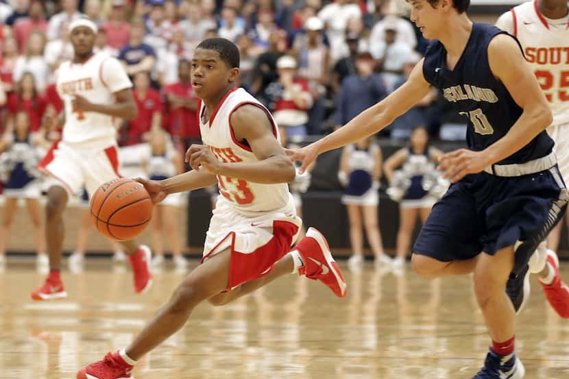 South Grand Prairie freshman guard Bryce Cook (23) battles past Richland junior guard Landon...