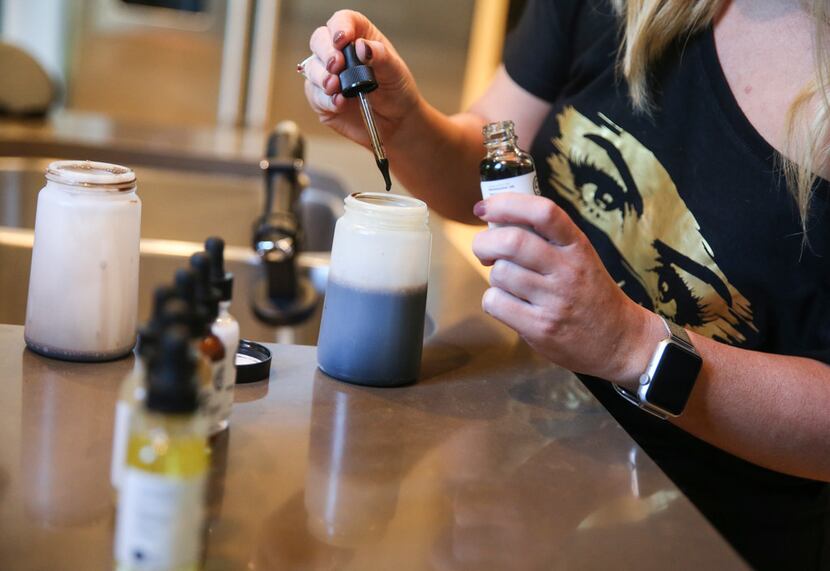 Stephanie Lynch of No Bad Looks spray tanning prepares chemicals for an in home spray tan.