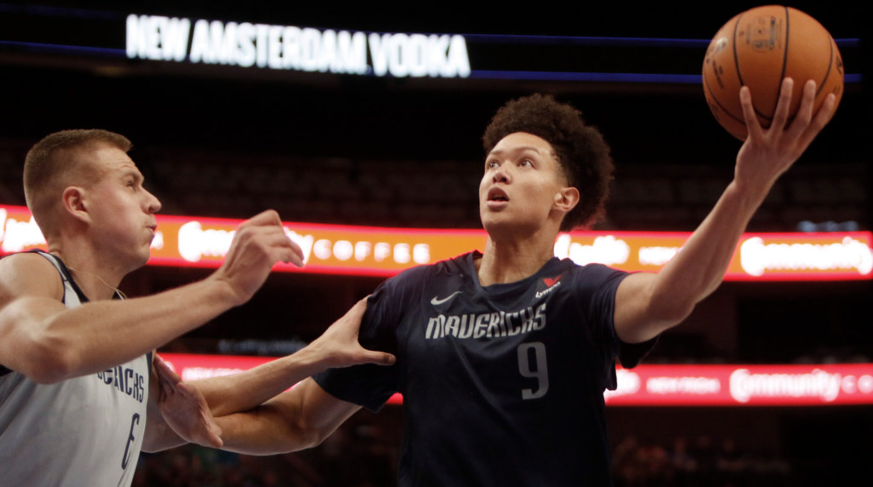 Dallas Mavericks forward Isaiah Roby (9) drives to the basket as center Kristaps Porzingis...