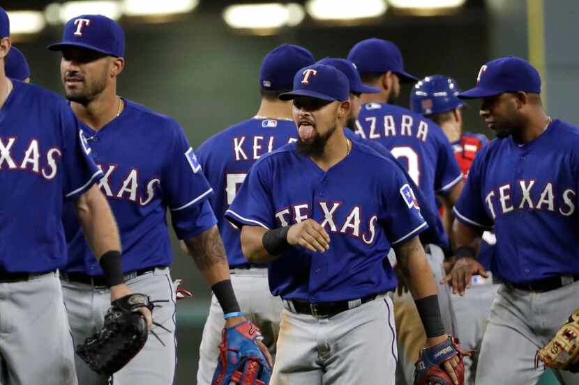 Texas Rangers' Rougned Odor, center, celebrates with teammates after beating the Houston...