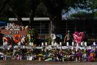 \Flowers and candles are placed around crosses on May 28, 2022, at a memorial outside Robb...
