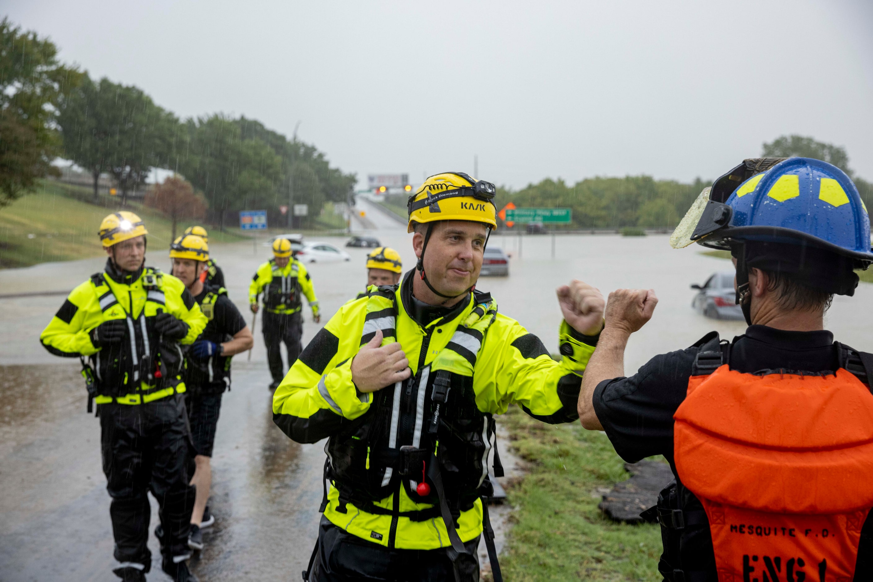 Lieutenant Zac Bell (center) fist bumps a fellow member of the Mesquite Fire Department as...