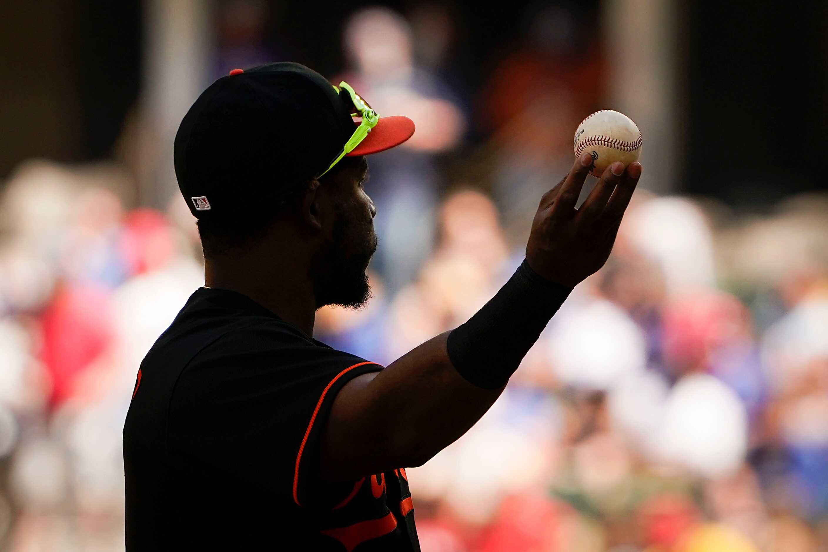 Baltimore Orioles third baseman Maikel Franco holds the ball before returning it to the...