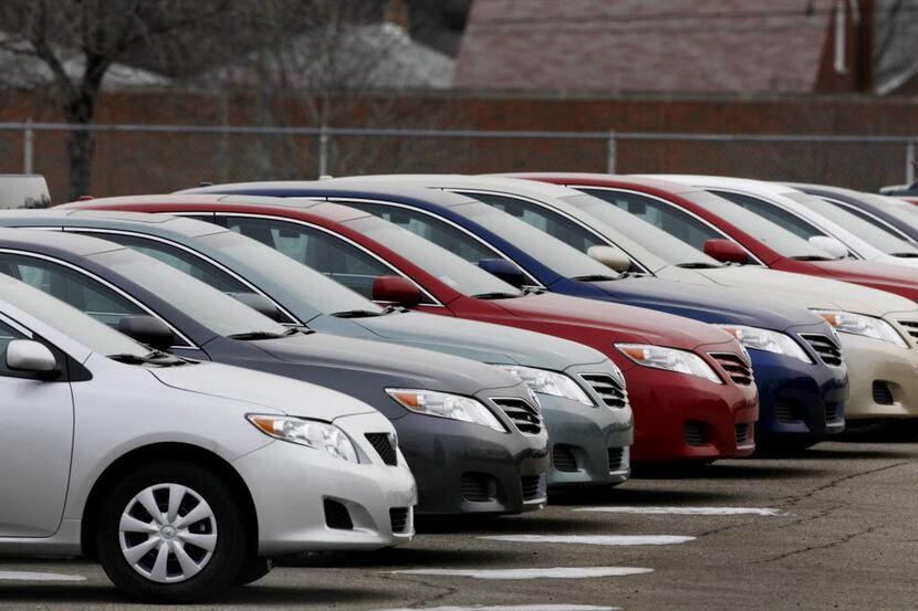 Toyota Corolla and Camrys are shown in a fenced lot behind a dealership in Warren, Mich.