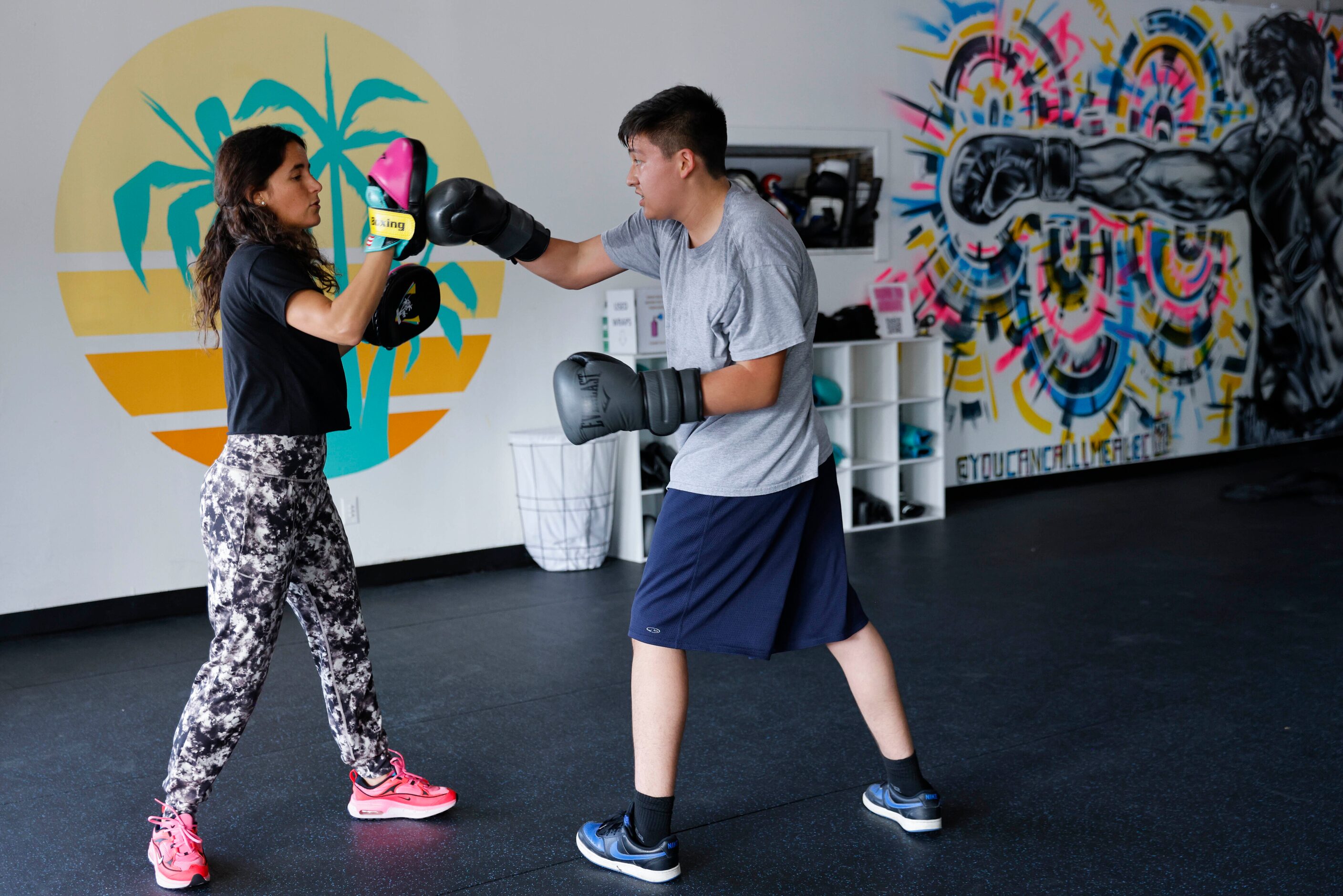 Amanda Alvarez, a salsa teacher and boxing lover, trains Eduardo Soto during a boxing...