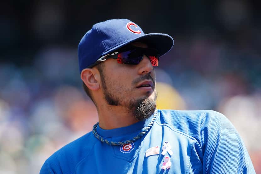 Chicago Cubs pitcher Matt Garza looks on against the Colorado Rockies in the first inning of...