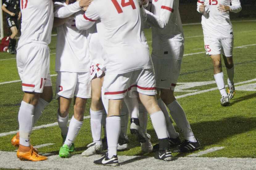 The Coppell boys celebrate a goal together during their UIL 6A boys State Championship...