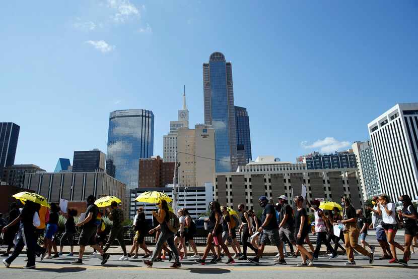 Protesters march on Young street in downtown Dallas during the Lead the Change: Juneteenth...