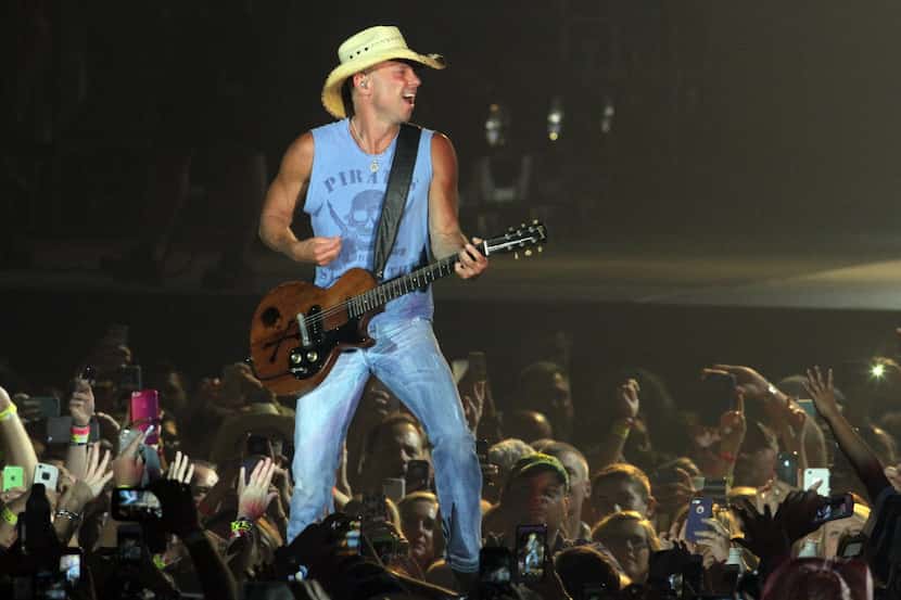 Country music recording artist Kenny Chesney gets close to his fans as he performed as part...