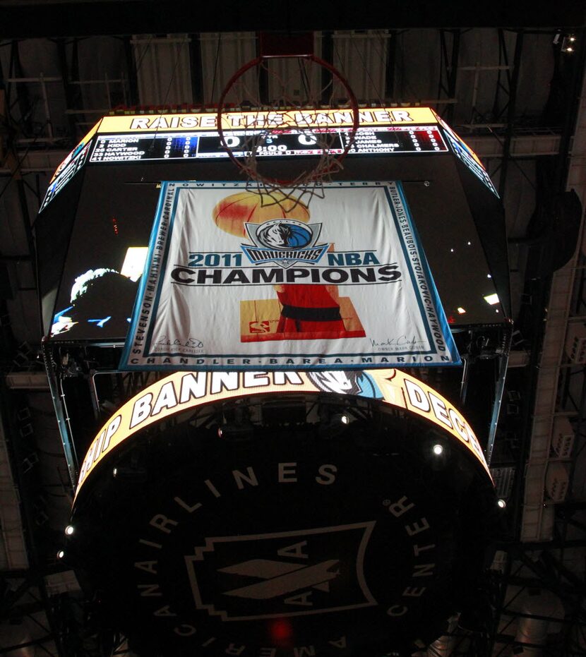 The Dallas Mavericks Championship banner is raised prior to their game against the Miami...