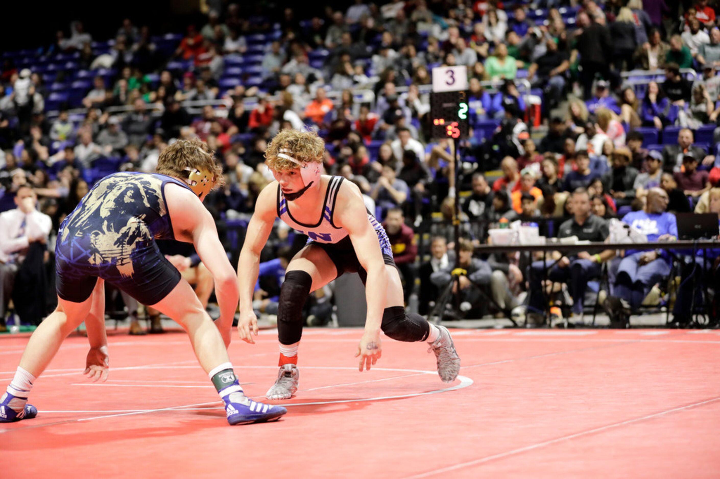 Parker Decker of Keller wrestles against Tagen Jamison of Plano West during the UIL Texas...