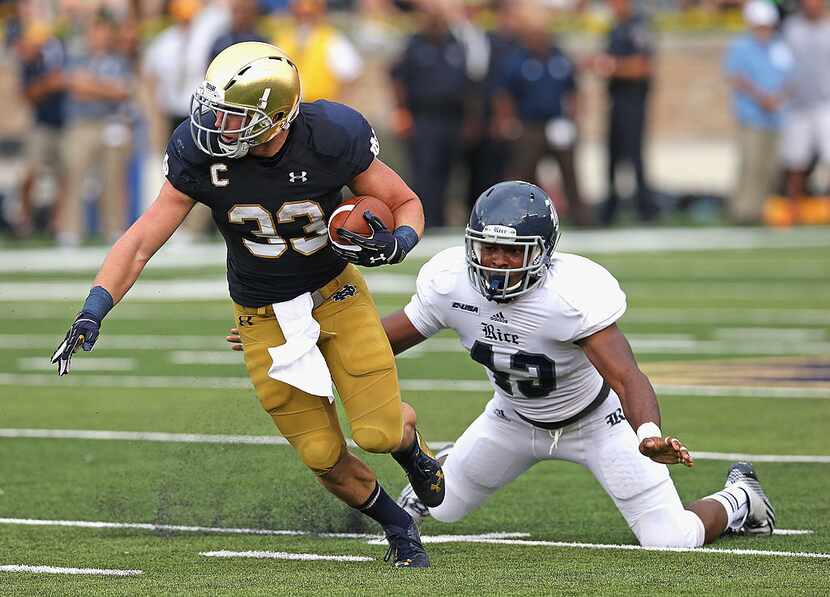 SOUTH BEND, IN - AUGUST 30:  Cam McDaniel #33 of the Notre Dame Fighting Irish breaks away...