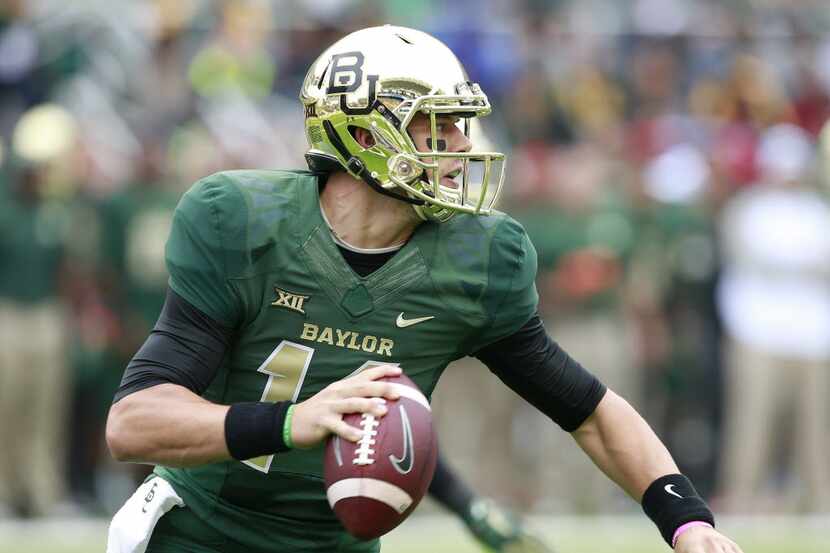 Baylor quarterback Bryce Petty (14) looks downfield against TCU in the first half of their...