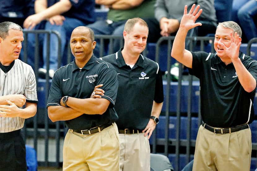 Plano West head coach Anthony Morgan (left center) tries to get an explanation for a call...