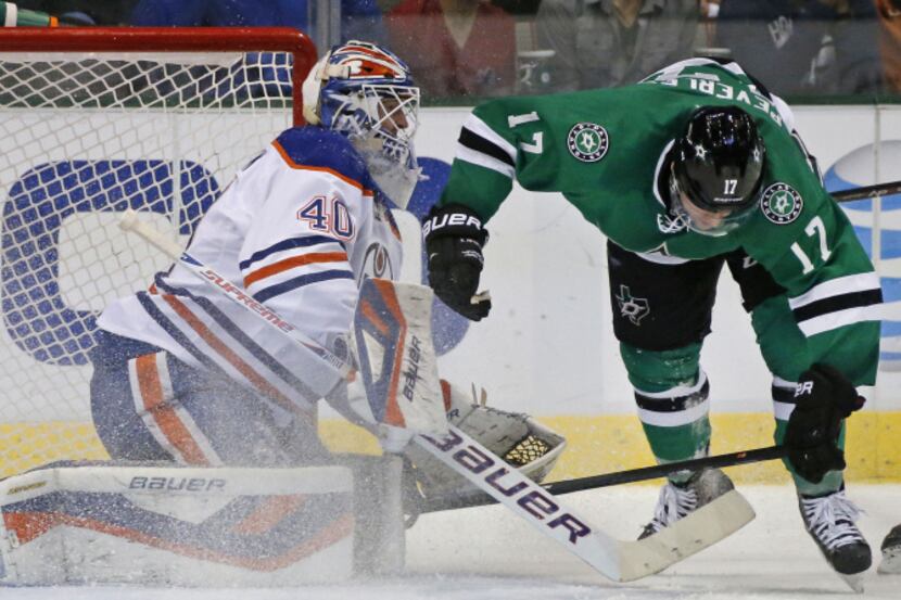 Dallas' Rich Peverley (17) tries to maintain his balance in front of edmonton goalie Devan...