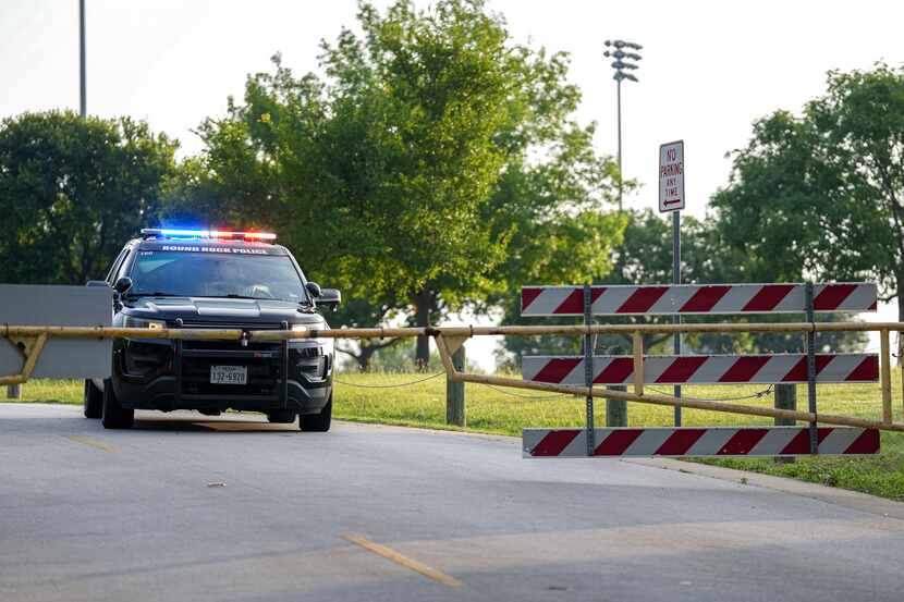 A Round Rock Police Department vehicle blocks Harrell Parkway at Old Settlers Park after a...