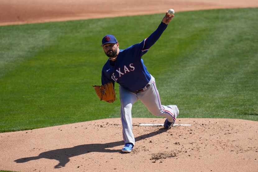 Texas Rangers starting pitcher Martin Perez (54) throws during the first inning of a spring...