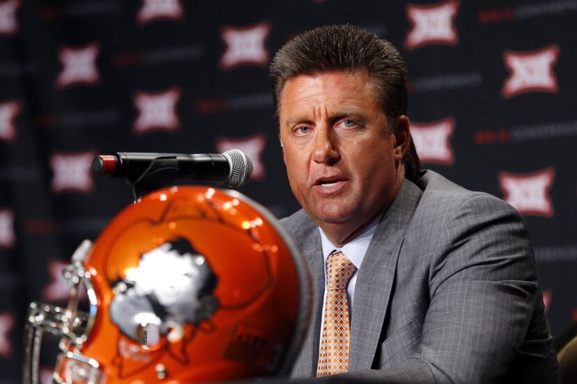 Oklahoma State head football coach Mike Gundy responds to questions from the media during...
