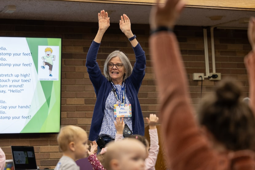 Susan McGinnis teaches kids a song during their weekly story time at the Preston Royal...