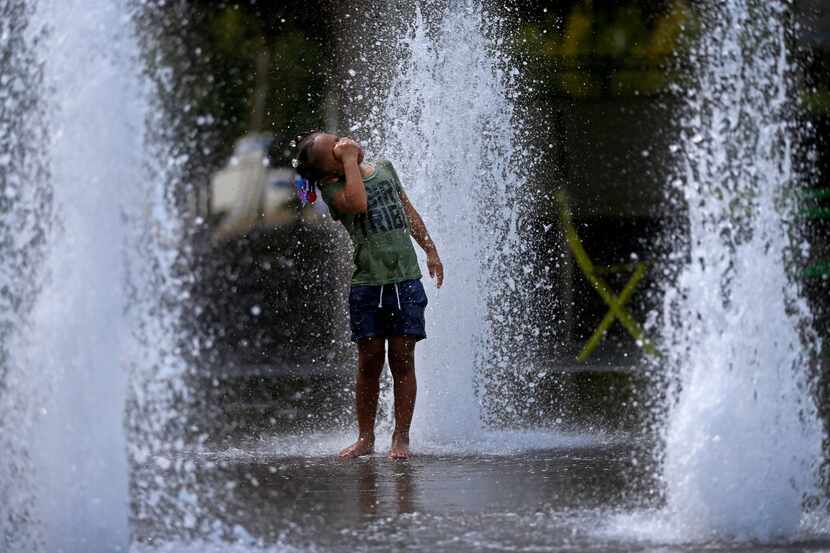 Rhmyeiah Parrish, 5, cooled off in the fountain at Klyde Warren Park in Dallas on July 19...