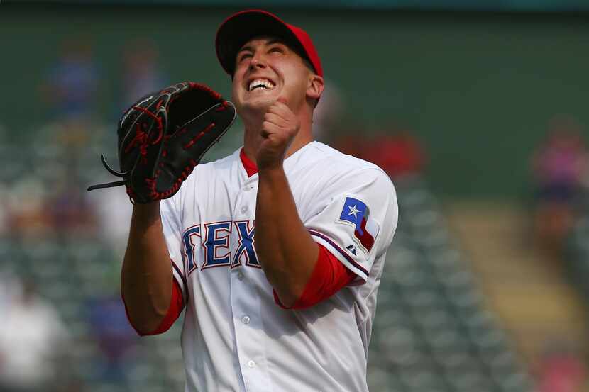 ARLINGTON, TX - AUGUST 30:  Derek Holland #45 of the Texas Rangers celebrates after throwing...