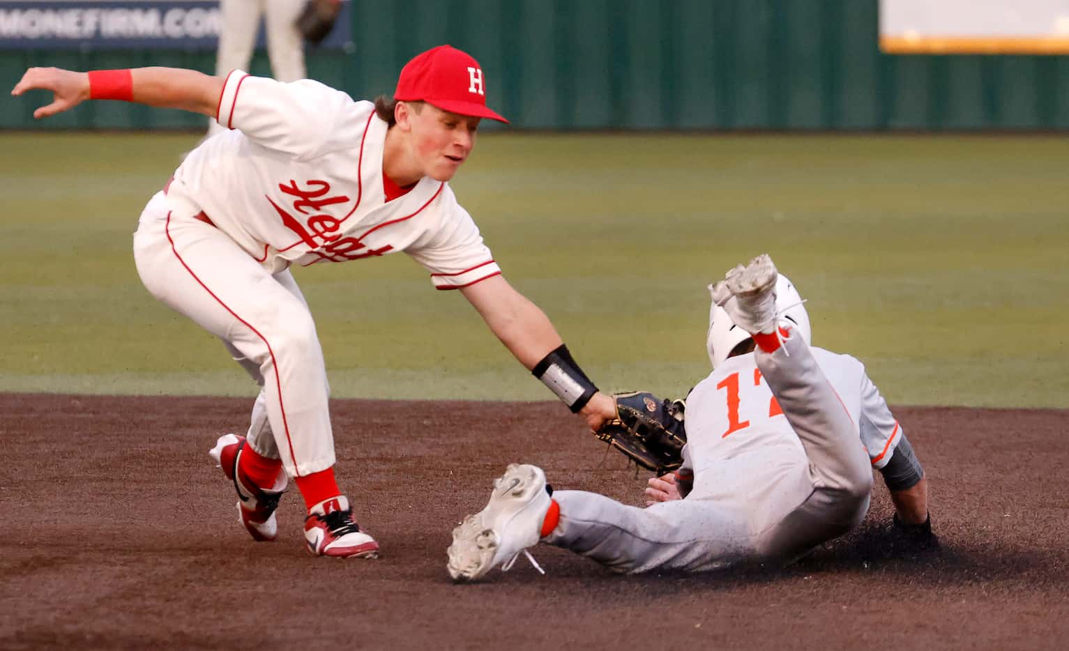 Rockwall-Heath shortstop Alex Cooley tags Celina’s Colin Thode (17) on a second-inning...