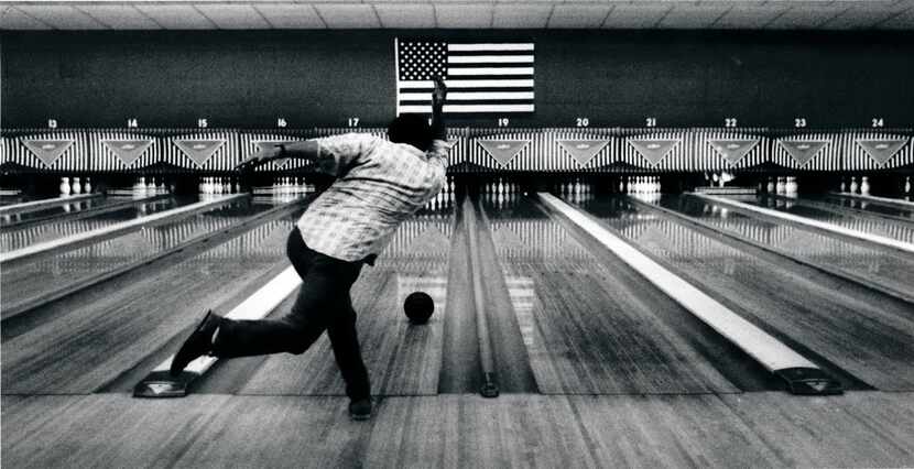 Charlie McPhee takes a shot in the Bronco Bowl's lanes April 18, 1990 in Dallas. (Catharine...