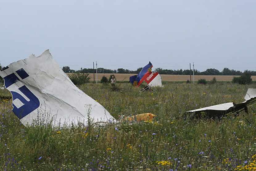 Pieces of wreckage of the Malaysia Airlines flight MH17 litter a field Friday in Shaktarsk,...