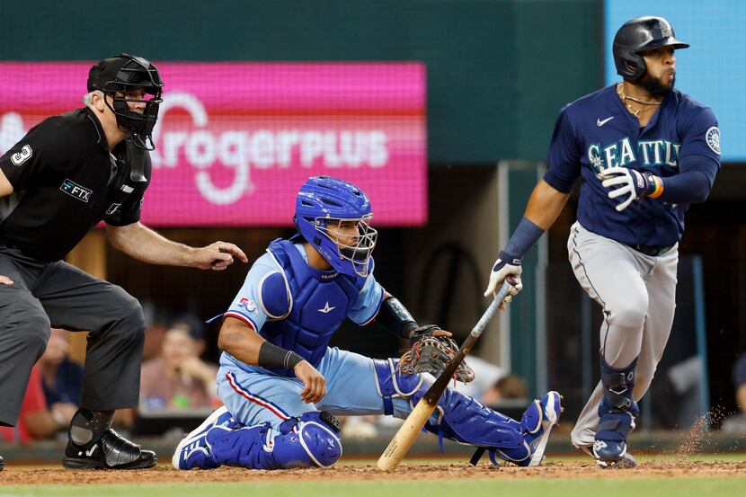 Texas Rangers catcher Meibrys Viloria (60) watches as Seattle Mariners designated hitter...