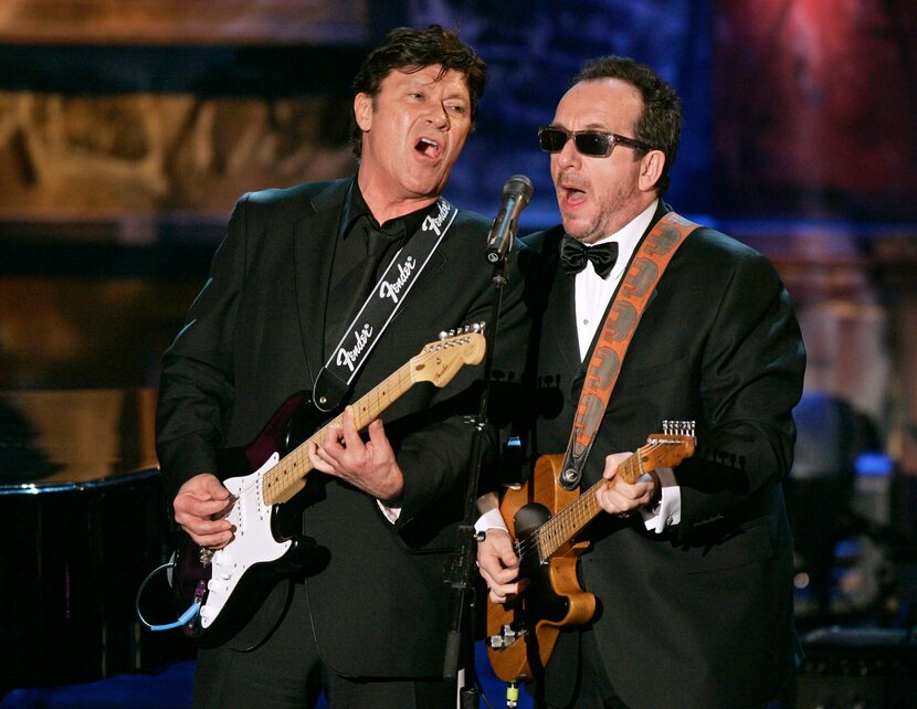 FILE - Robbie Robertson, left, and Elvis Costello play in an all-star tribute to New Orleans...