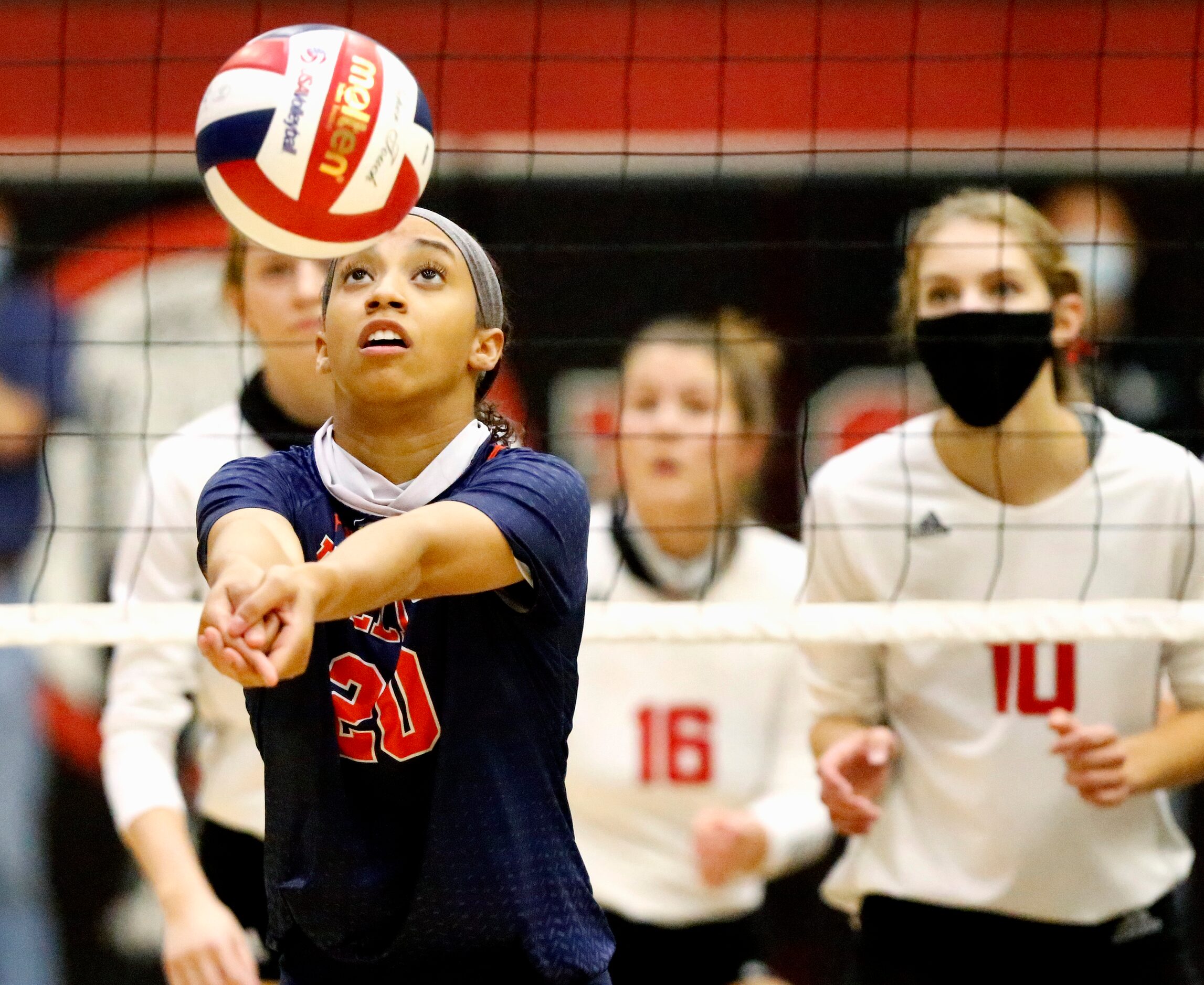 McKinney North High School middle hitter Nylah Encalade (20) passes the volleyball during...