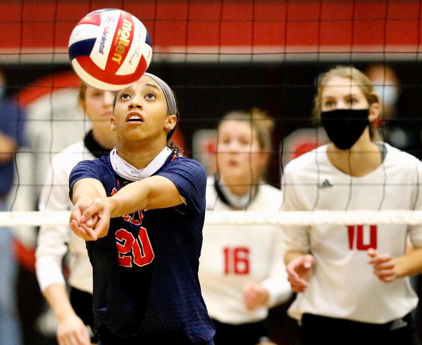 McKinney North High School middle hitter Nylah Encalade (20) passes the volleyball during...