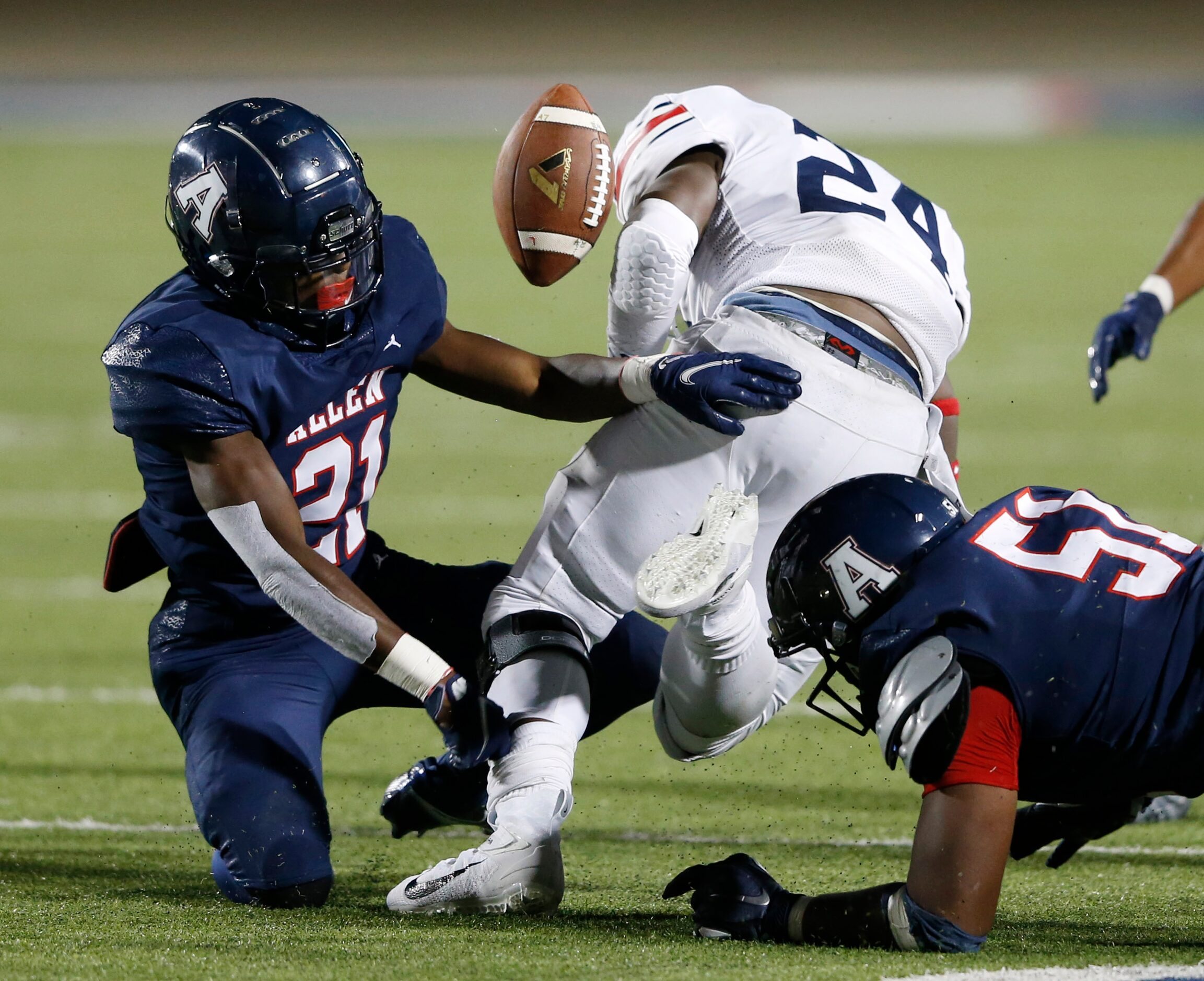 Allen's Nicholas Bargains (21) forces  Humble Atascocita's Quincy Thompson (24) to fumble...