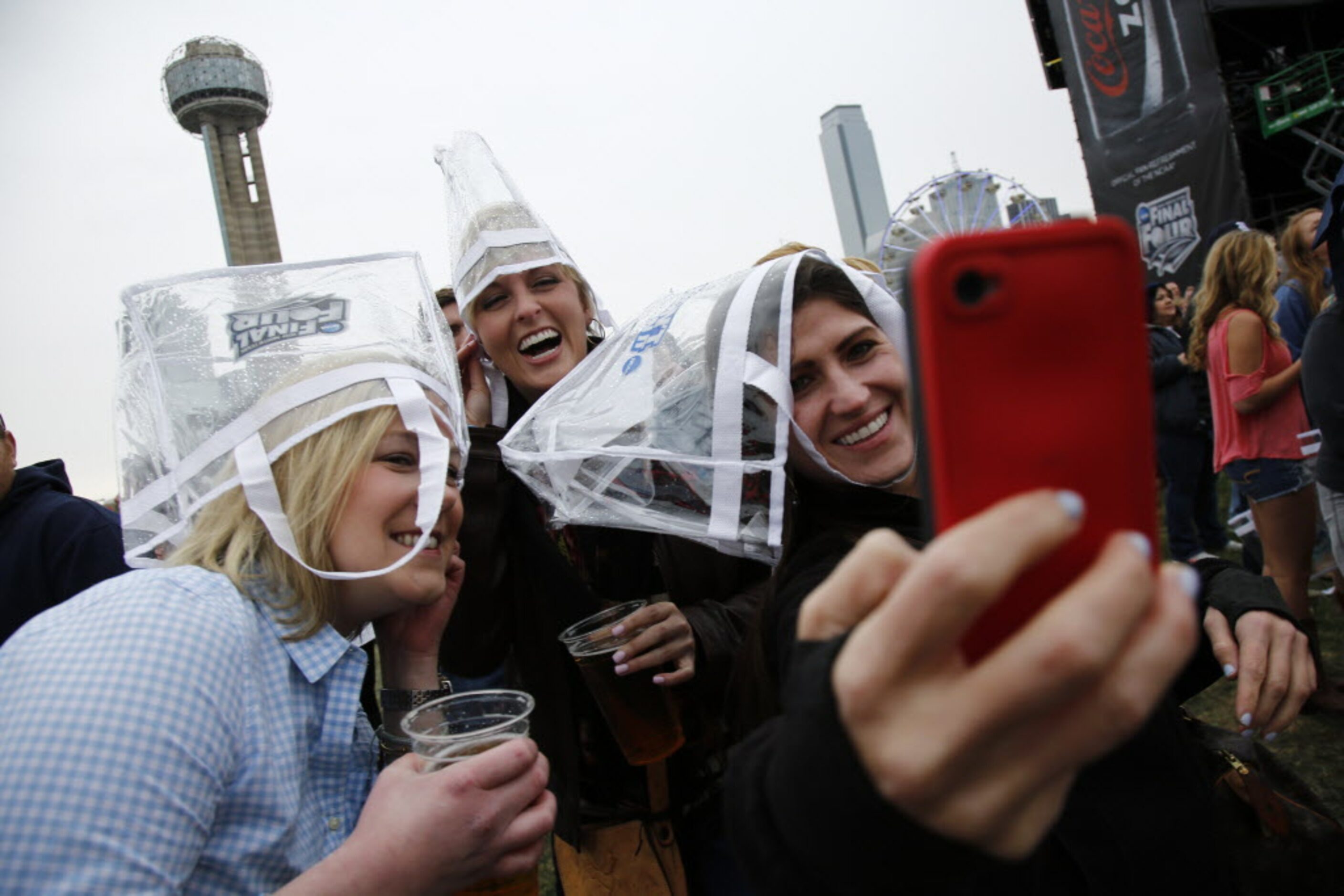 Jennifer Halle (left to right), Julie Merritt and Kerri Sasso take a group selfie as they...