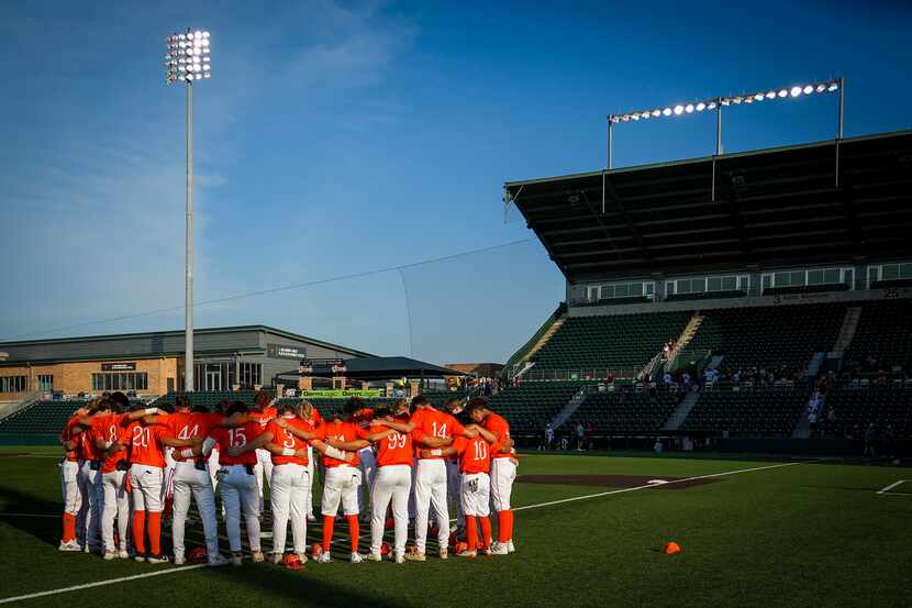 Celina players huddle in the outfield after a loss to Sinton in a UIL 4A baseball state...